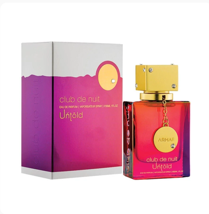 Armas Club de Nuit Unfolded cologne spray bottle and its packaging box, featuring a vibrant pink and purple gradient design with gold accents.
