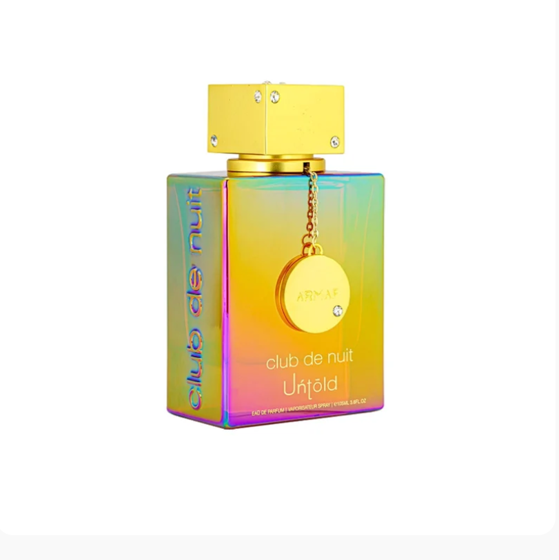 A rectangular perfume bottle with an iridescent rainbow finish, a metallic gold cap, and a hanging gold medallion, shown on a plain white background.